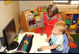 Foster Grandparent teaching computer skills.