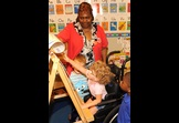 Foster Grandparent provides assistance to a child with special needs